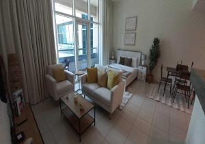 a living room with a couch and a table at Bay Square studio Bay view in Dubai