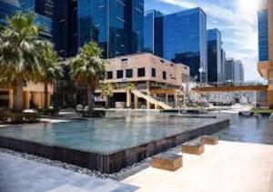 a fountain in the middle of a city with tall buildings at Bay Square studio Bay view in Dubai