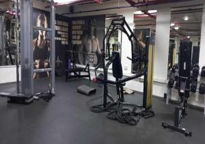 a gym with several machines and people in it at Bay Square studio Bay view in Dubai