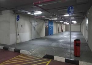 an empty parking garage with a trash can in it at Bay Square studio Bay view in Dubai