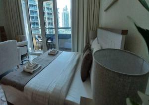 a bedroom with a large bed and a large window at Bay Square studio Bay view in Dubai