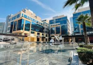 a group of buildings with chairs in front of it at Bay Square studio Bay view in Dubai