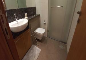 a bathroom with a sink and a toilet at Bay Square studio Bay view in Dubai