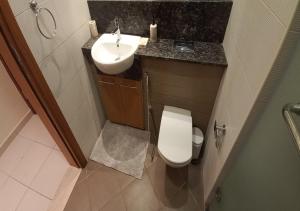 a small bathroom with a sink and a toilet at Bay Square studio Bay view in Dubai