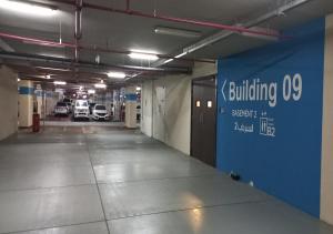an empty parking garage with a blue wall at Bay Square studio Bay view in Dubai