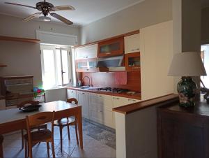 a kitchen with a table and chairs and a dining room at Aurora and Brothers' home in Falerna Marina