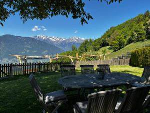 a table and chairs with a view of mountains at Bergchalet Platzl in Verano