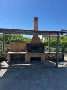 a picnic shelter with a pizza oven in a park at Country House Nannos in Néa Thésis
