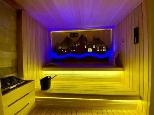 a room with avisor with purple lights in a room at Elia Residence Rooms in Bečići