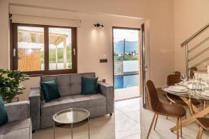 a living room with a couch and a table at Zante way villas in Zakynthos