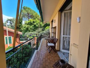 a balcony with a table and a chair at Turchino Apartment & Terrazza della Luisa by PortofinoVacanze in Santa Margherita Ligure