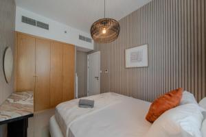 a bedroom with a large white bed in a room at 1Bedroom & Living room Apartment - The Sahara Suite in Sharjah Intl