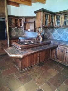 a kitchen with a wooden island in the middle at Vryburg Good Time Yafe Guest House in Vosburg