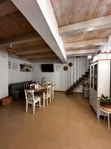 a kitchen and dining room with a table and chairs at Wanderlust Cottage Avrig in Avrig +43 photos