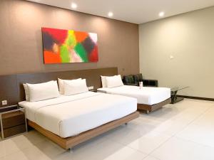 Voodi või voodid majutusasutuse Savana Hotel & Convention Malang toas