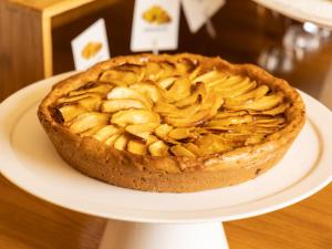 a apple pie on a white plate on a table at Hotel Cristallo in Giulianova