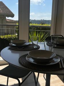 a table with bowls and plates on it with a view at AMoR in Salò