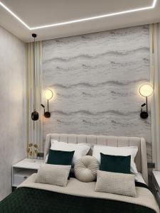 a bedroom with a large bed with green and white pillows at Riviera Sea Apartments in Fontanka +103 photos