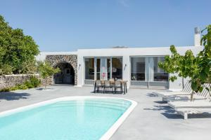 a villa with a swimming pool and a patio at Thermes Luxury Villas by Mr and Mrs White in Megalochori