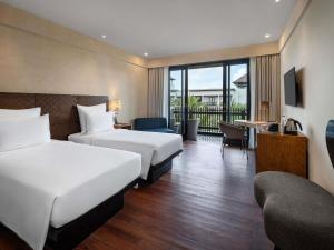 Postel nebo postele na pokoji v ubytování Pullman Bali Legian Beach