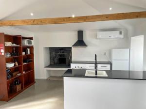 a kitchen with a sink and a fireplace at Quinta do Almanac in Queimada +14 photos