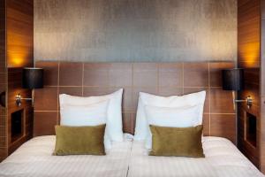 a bedroom with a bed with two pillows at Scandic Simonkenttä in Helsinki