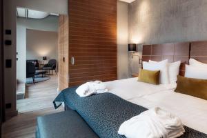 a hotel room with a bed with towels on it at Scandic Simonkenttä in Helsinki