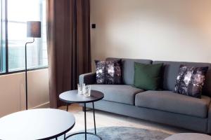 a living room with a couch and a table at Scandic Simonkenttä in Helsinki
