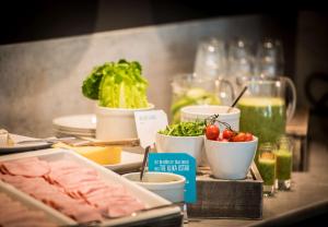 a buffet with meat and vegetables on a table at Scandic Simonkenttä in Helsinki