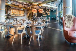 a row of tables and chairs in a restaurant at Scandic Simonkenttä in Helsinki