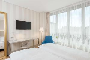 Voodi või voodid majutusasutuse NH Graz City toas