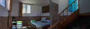 a bedroom with a bed in a room with a staircase at Casa Petrino in Samos