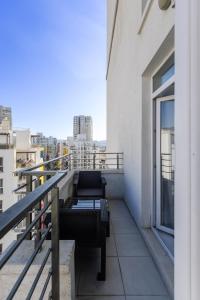 a balcony with a bench and a view of a city at Magnificent Diamond Duplex in Tbilisi City