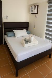 Ένα ή περισσότερα κρεβάτια σε δωμάτιο στο Kasara Urban Resort & Residences