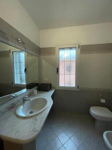 a bathroom with a sink and a toilet at Appartamento Gallospot in San Teodoro +15 photos
