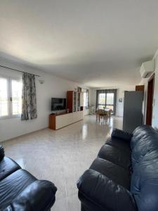 a large living room with a couch and a table at Appartamento Gallospot in San Teodoro