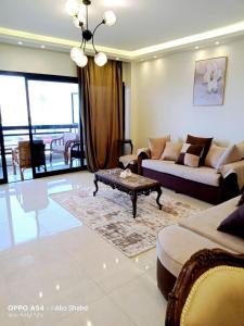 a living room with a couch and a coffee table at Gleem Bay ultra lux Apartment in Alexandria