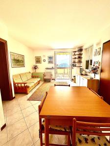 a living room with a table and a couch at Wonder View - relax and nature in Varenna +19 photos