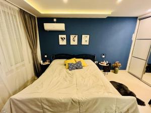 a bedroom with a large bed with a blue wall at Sarajevo Stories Apartments Free Parking in Sarajevo