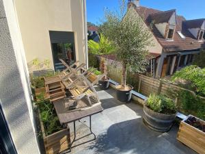 eine Gruppe von Stühlen auf einer Terrasse in der Unterkunft Villa riviera hammam, piscine & jacuzzi in La Ferté-Alais