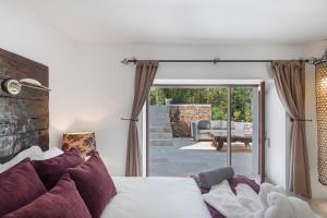 a bedroom with a bed and a sliding glass door at Can Ribes Ibiza in Illes Balears +37 photos