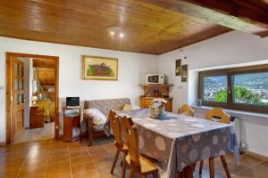 a dining room with a table and chairs in a room at Chez Emilia Mansarda in Aosta
