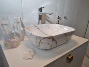 a bathroom with a marble sink on a counter at Apartment Lučka in Rab +33 photos