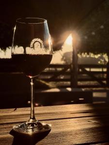 a glass of wine sitting on a wooden table at Thuysgrond in Bergeijk