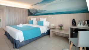 a bedroom with a large bed with a painting on the wall at Labranda Marieta & Spa - Adults Only in Playa del Ingles
