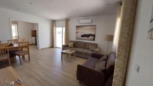 a living room with a couch and a table at Villa in Salgados Golf - Albufeira in Guia