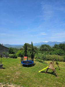two playground equipment in a grassy field at A Casa Di a Vita in Rapale