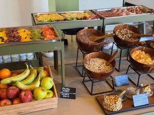 a display of different types of fruits and vegetables at La Griffe Hotel Roma in Rome