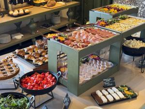 a buffet with many different types of food on display at La Griffe Hotel Roma in Rome