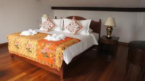a bedroom with a bed with two towels on it at Heeren Straits Hotel in Malacca